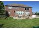 Lush backyard featuring a brick home, patio, fire pit, and play area, perfect for Gathering enjoyment at 2219 Stone Manor Ct, Avon, IN 46123