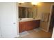 En-suite bathroom featuring double sinks, walk-in closet, and a large mirror at 2219 Stone Manor Ct, Avon, IN 46123