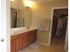 En-suite bathroom featuring double sinks, walk-in closet, and a large mirror at 2219 Stone Manor Ct, Avon, IN 46123