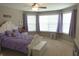 Bedroom boasting large bay windows, a ceiling fan, and a white wood bed frame with a white storage bench at 2219 Stone Manor Ct, Avon, IN 46123