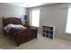 Well lit bedroom features a wood bed frame, neutral paint, and a white bookshelf at 2219 Stone Manor Ct, Avon, IN 46123