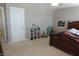 Bedroom featuring a wood bed frame, neutral walls, and a white door at 2219 Stone Manor Ct, Avon, IN 46123