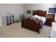 Bedroom featuring a wood bed frame, neutral walls, and a white bookshelf with plenty of storage at 2219 Stone Manor Ct, Avon, IN 46123