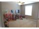 Large bedroom with toys, dollhouse, a ceiling fan, and a window at 2219 Stone Manor Ct, Avon, IN 46123