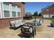 Relaxing patio featuring a fire pit, comfortable seating, and brick exterior of home at 2219 Stone Manor Ct, Avon, IN 46123