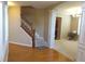 Inviting foyer featuring hardwood floors, staircase, and elegant archway leading to a carpeted living area at 2219 Stone Manor Ct, Avon, IN 46123