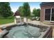 Outdoor hot tub with built-in grill and seating area on a well-manicured lawn, perfect for entertaining at 2219 Stone Manor Ct, Avon, IN 46123