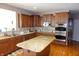 Spacious kitchen featuring stainless steel appliances, granite countertops and wood cabinets at 2219 Stone Manor Ct, Avon, IN 46123