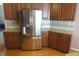 Modern kitchen featuring stainless steel refrigerator, granite countertops, and wood cabinets at 2219 Stone Manor Ct, Avon, IN 46123