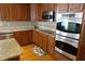 Well-equipped kitchen boasting stainless appliances, granite countertops, and ample wood cabinetry at 2219 Stone Manor Ct, Avon, IN 46123
