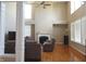 Open-concept living room with fireplace, hardwood floors, and abundant natural light at 2219 Stone Manor Ct, Avon, IN 46123