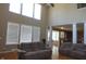 Bright living room with hardwood floors, fireplace, and seamless flow to the kitchen at 2219 Stone Manor Ct, Avon, IN 46123