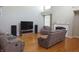 Cozy living room featuring a fireplace, hardwood floors, and entertainment center at 2219 Stone Manor Ct, Avon, IN 46123