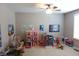 Spacious playroom featuring a ceiling fan and an array of toys and play structures at 2219 Stone Manor Ct, Avon, IN 46123
