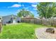 This fenced backyard includes a shed, a fire pit and a well-manicured lawn, offering outdoor space at 2303 Midway St, Columbus, IN 47201