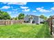 Spacious fenced backyard featuring a shed and patio area with grill, perfect for entertaining or relaxing at 2303 Midway St, Columbus, IN 47201