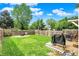 Spacious fenced backyard with a fire pit and a deck area with a grill, ideal for outdoor entertaining at 2303 Midway St, Columbus, IN 47201