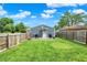 Fenced backyard features a shed and a patio area with a grill and seating, perfect for outdoor living at 2303 Midway St, Columbus, IN 47201