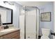 Bathroom with a modern shower, granite countertop, and a decorative picture on the wall at 2303 Midway St, Columbus, IN 47201