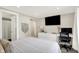 Bedroom featuring a tv, desk, white dresser, and a view to the ensuite bathroom through the doorway at 2303 Midway St, Columbus, IN 47201