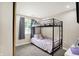Charming bedroom with a bunk bed, carpet flooring and a window, creating a comfortable and inviting space at 2303 Midway St, Columbus, IN 47201