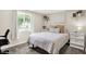 Cozy bedroom with natural light, neutral color palette, and decorative shelves and plants at 2303 Midway St, Columbus, IN 47201