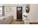 Inviting entryway featuring hardwood floors, decorative mirror, and accent furniture that offers a warm welcome at 2303 Midway St, Columbus, IN 47201