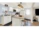 Modern white kitchen with stainless steel appliances, stylish lighting, and a breakfast bar that is great for socializing at 2303 Midway St, Columbus, IN 47201