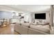 Open-concept living room seamlessly connects to the kitchen, perfect for modern living and entertaining guests at 2303 Midway St, Columbus, IN 47201