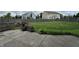 View of the backyard with a concrete patio, lush green grass, and a wooden fence at 2680 Newington Ln, Carmel, IN 46074