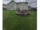 Expansive backyard featuring a stone fire pit and view of the home's exterior at 2680 Newington Ln, Carmel, IN 46074