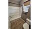 Bathroom showcasing a white shower/tub combo and a toilet next to the window with blinds at 2680 Newington Ln, Carmel, IN 46074