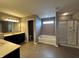 Luxurious bathroom with a separate tub and shower, and dual vanity sinks at 2680 Newington Ln, Carmel, IN 46074