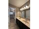 Bathroom featuring a double vanity with a mirror and two lights and a view into the toilet/shower room at 2680 Newington Ln, Carmel, IN 46074
