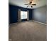 Spacious bedroom features neutral carpet, a ceiling fan and blue accent wall at 2680 Newington Ln, Carmel, IN 46074