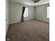 Neutral carpeted bedroom with natural light and modern ceiling fan at 2680 Newington Ln, Carmel, IN 46074