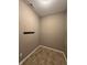 Small closet with hooks for hanging items and tile floor at 2680 Newington Ln, Carmel, IN 46074