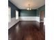 Elegant dining room featuring wainscoting, hardwood floors, and modern lighting at 2680 Newington Ln, Carmel, IN 46074