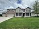 Charming two-story home featuring a welcoming front porch and three-car garage at 2680 Newington Ln, Carmel, IN 46074