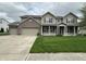 Charming two-story home featuring a welcoming front porch and three-car garage at 2680 Newington Ln, Carmel, IN 46074