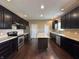 Spacious kitchen features dark cabinets, stainless steel appliances and center island at 2680 Newington Ln, Carmel, IN 46074