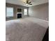 Large living room with fireplace and neutral carpeting at 2680 Newington Ln, Carmel, IN 46074