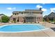 Exterior view of home's backyard with gunite pool, poolhouse and screened porch at 28 Hudson Bay Ln, Greenwood, IN 46142
