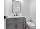 Stylish powder room with gray vanity, modern faucet and matte black framed mirror at 28 Hudson Bay Ln, Greenwood, IN 46142