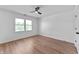 Neutral bedroom with hard wood floors, fan, and a large window that provides natural light at 28 Hudson Bay Ln, Greenwood, IN 46142
