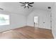 Bedroom with hardwood floors, fan, natural light, and view of the bathroom through the doorway at 28 Hudson Bay Ln, Greenwood, IN 46142