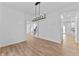 Dining room with hardwood floors, chandelier, and view of the rest of the home at 28 Hudson Bay Ln, Greenwood, IN 46142