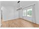 Dining room with hardwood floors, chandelier, natural light, and neutral walls at 28 Hudson Bay Ln, Greenwood, IN 46142