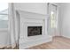 Elegant white brick fireplace with mantel, flanked by windows and draperies, adding warmth to the living space at 28 Hudson Bay Ln, Greenwood, IN 46142