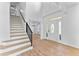 Bright foyer with staircase, chandelier, and hardwood floors throughout the home at 28 Hudson Bay Ln, Greenwood, IN 46142